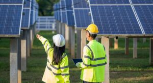 Workers Overlooking Solar Farm