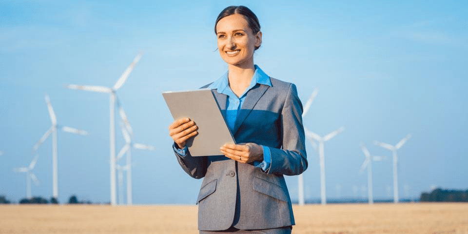 Women Smiling Standing in Windfarm Field for SEC Climate Disclosure