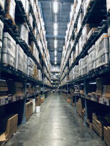 Photo of an aisle of a busy warehouse