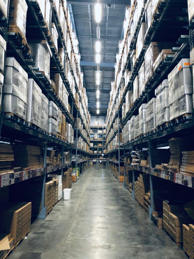Photo of an aisle of a busy warehouse