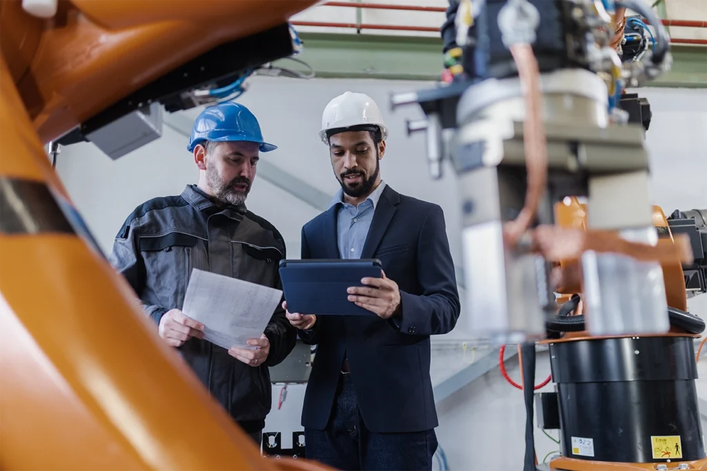 workers in production line looking at a tablet