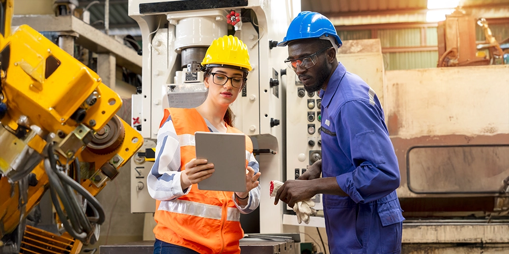 workers in production line looking at a tablet