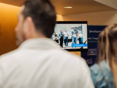Employees watching a live demonstration of an AI-powered, video-based ergonomic assessment.