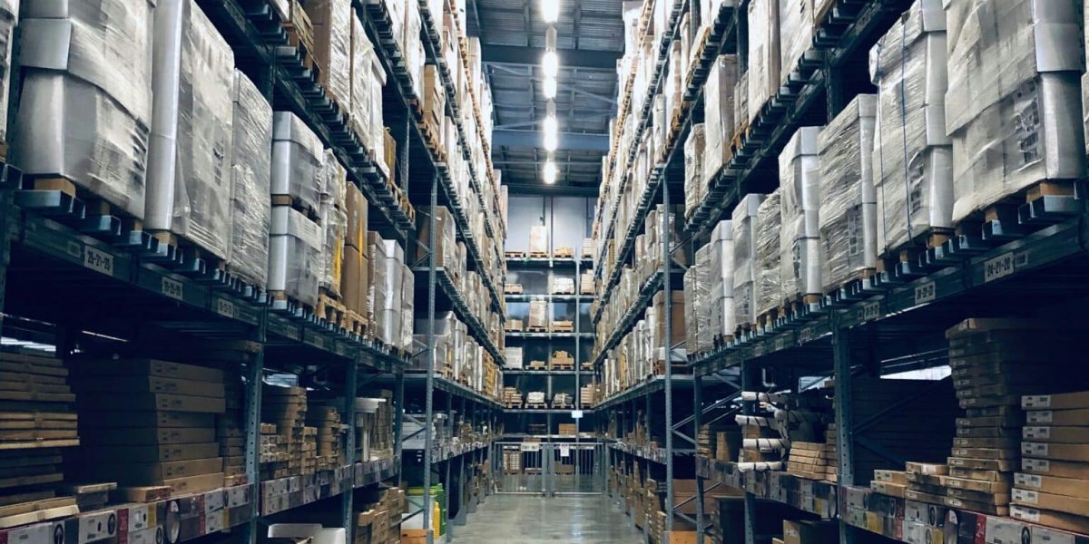 Photo of an aisle of a busy warehouse